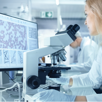 Female Research Scientist Using Electronic Microscope.